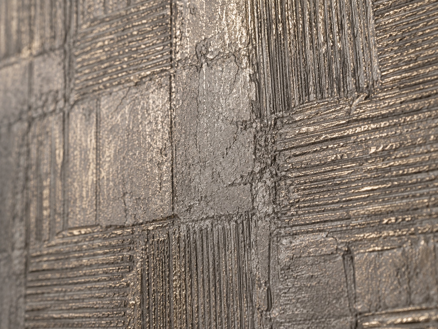 Imprint metallic stucco relief and linear marks, close detail